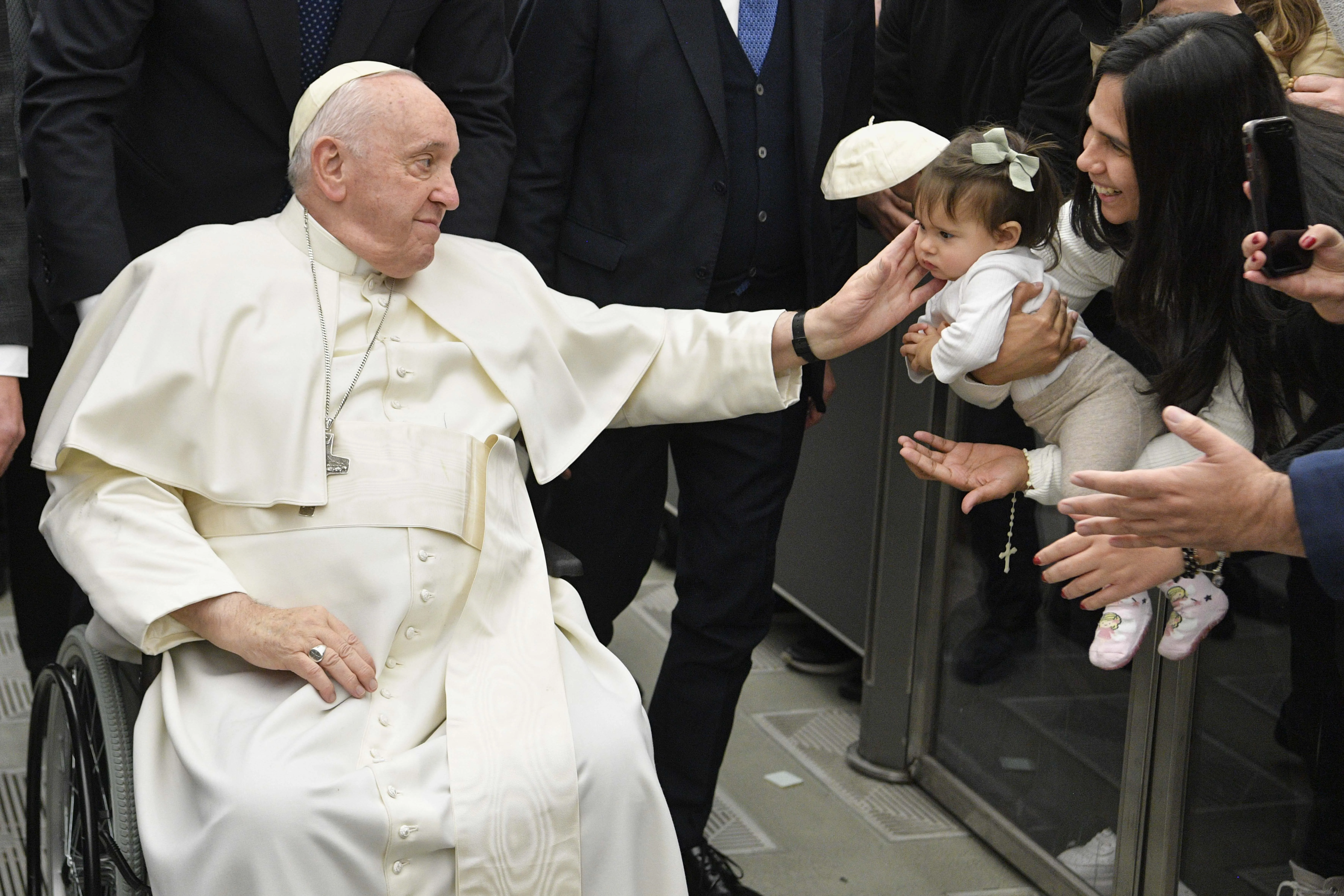 Pope Francis, seated in a wheelchair, greets a child during the pope's general audience at the Vatican on Jan. 25, 2023.?w=200&h=150
