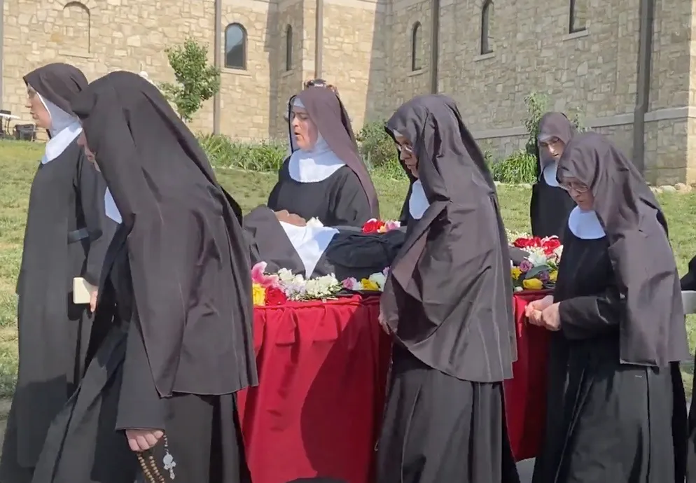 Religious sisters of the Benedictines of Mary, Queen of Apostles, sing as the process with the body of their late foundress, Sister Wilhelmina Lancaster, on May 29, 2023, at their abbey near Gower, Missouri. The sisters exhumed the nun's body on May 18 and discovered that it was apparently intact, four years after her death and burial in a simple wooden coffin.?w=200&h=150