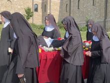 Religious sisters of the Benedictines of Mary, Queen of Apostles, sing as the process with the body of their late foundress, Sister Wilhelmina Lancaster, on May 29, 2023, at their abbey near Gower, Missouri. The sisters exhumed the nun's body on May 18 and discovered that it was apparently intact, four years after her death and burial in a simple wooden coffin.