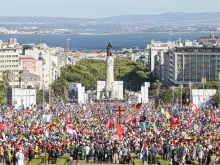 A view of the crowd and nearby waterfront at the opening Mass for World Youth Day in Lisbon, Portugal on Aug. 1, 2023.