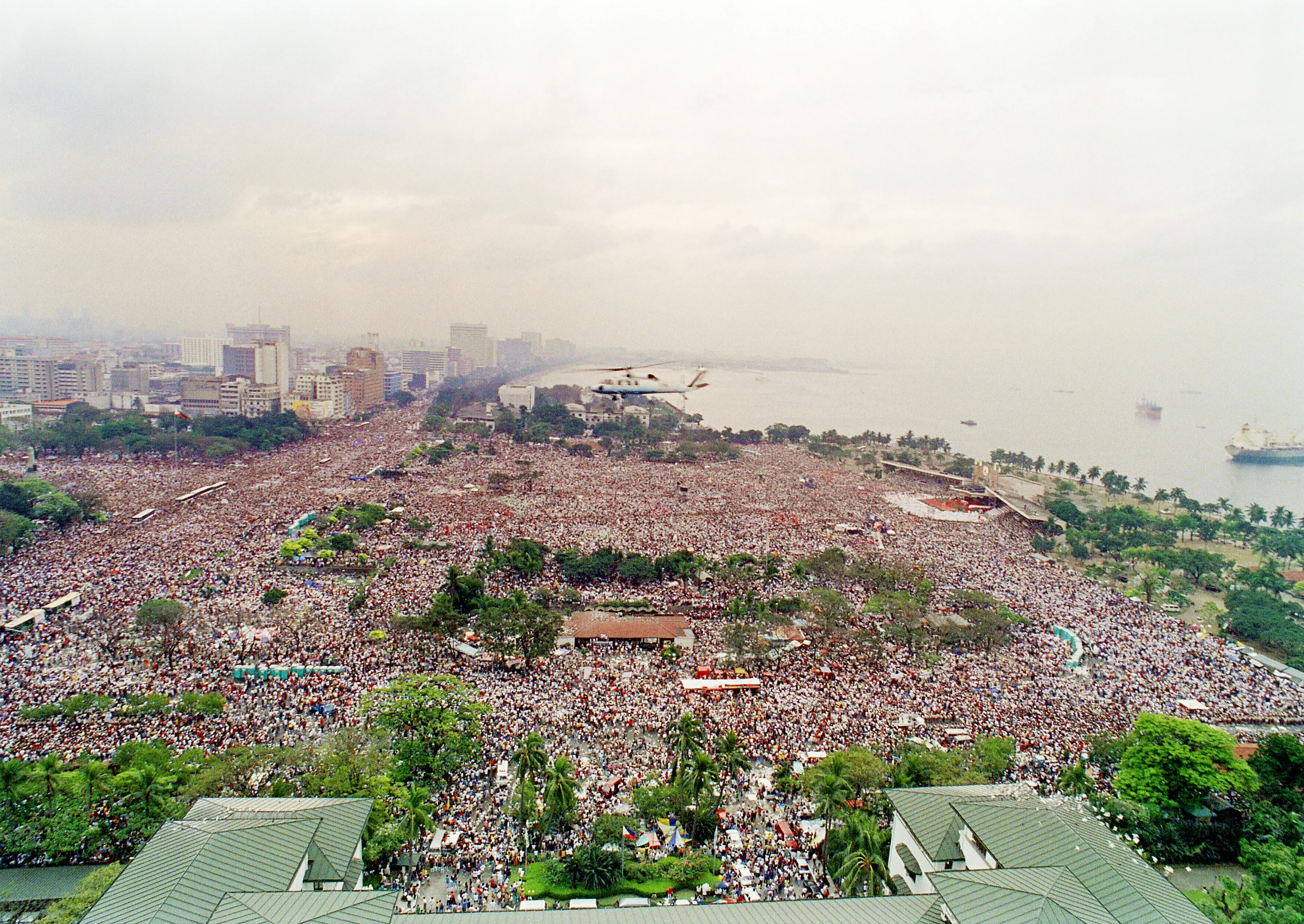 Pope John Paul II's helicopter flies over the huge crowd in Manila's Luneta Park prior to celebrating an open-air mass for an estimated two-million people gathered for the 10th World Youth Day on Jan. 15, 1995.?w=200&h=150