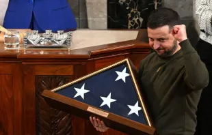 Ukraine's President Volodymyr Zelensky receives from U.S. House Speaker Nancy Pelosi (D-CA) (L) a US national flag during his address to the U.S. Congress at the U.S. Capitol in Washington, D.C. on Dec. 21, 2022. Mandel Ngan/AFP via Getty Images